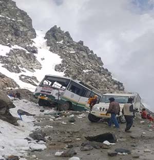 HRTC Bus and utility vehicle and passenger trapped in boulders hit bus at Saach Pass 